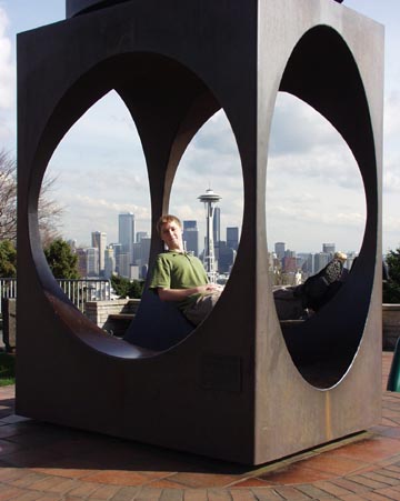 Me in a cube before the Seattle skyline.